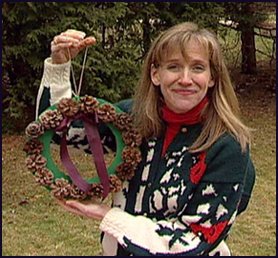Woman holding pinecone wreath Woman holding pinecone wreath